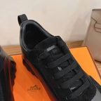 Unisex sneaker upper close-up, black lace and tongue logo patch on black fabric