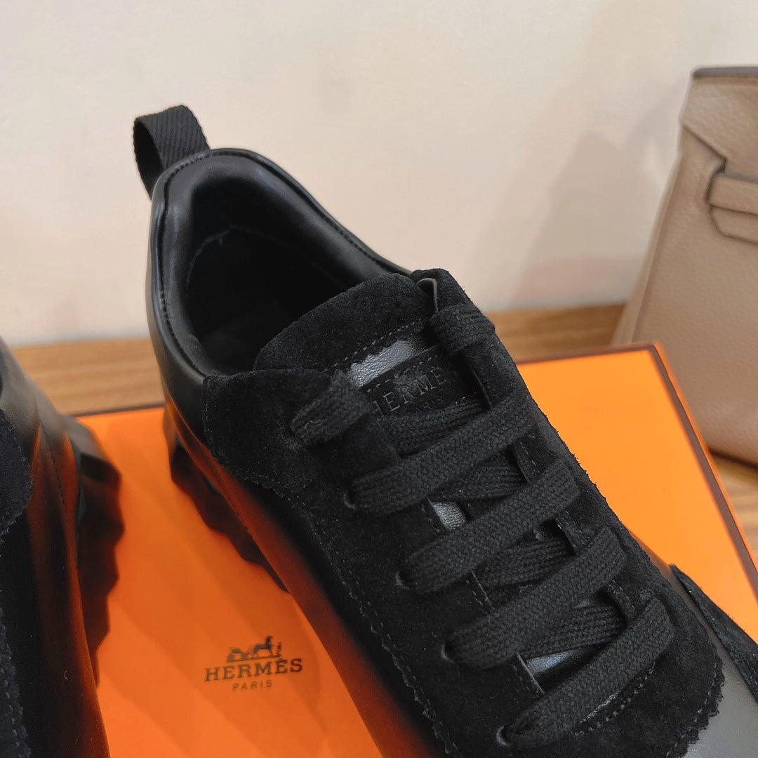 Unisex sneaker upper close-up, black lace and tongue logo patch on black fabric