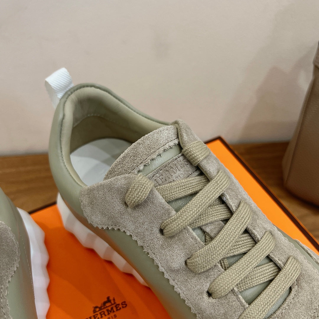 Hermes unisex sneakers, close-up of suede laces and tongue logo detail