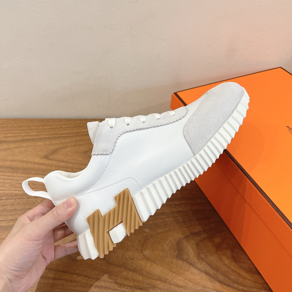 White sneaker with lace-up upper and ribbed chunky sole, side view