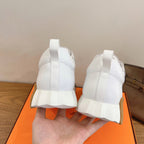 Back view of white lace-up sneakers with heel tabs and cushioned collar
