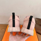 Hermes pink sneakers, back view with black heel tabs and chunky white sole
