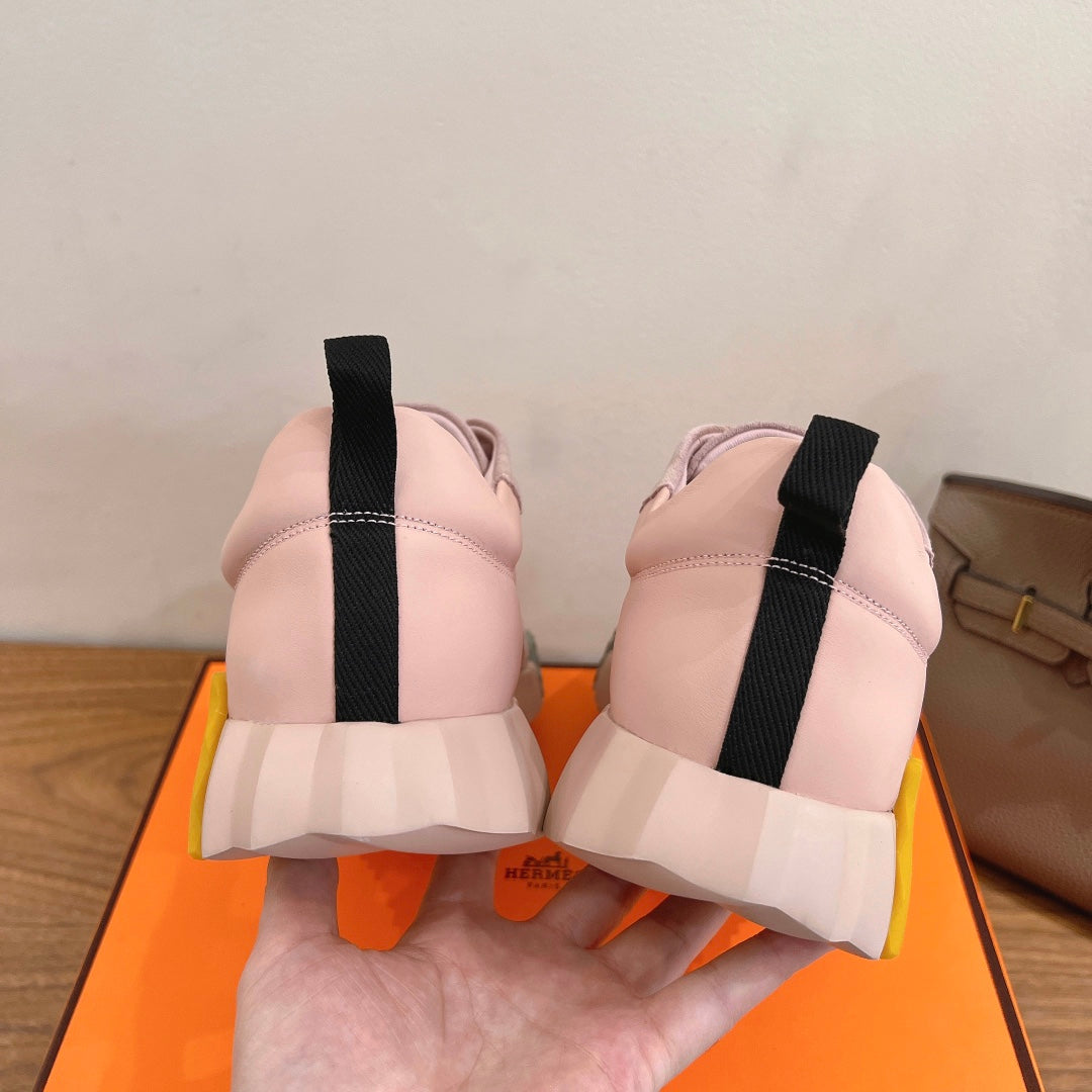 Hermes pink sneakers, back view with black heel tabs and chunky white sole