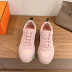 Hermes pink low-top sneakers with lace-up front and black heel loop detail
