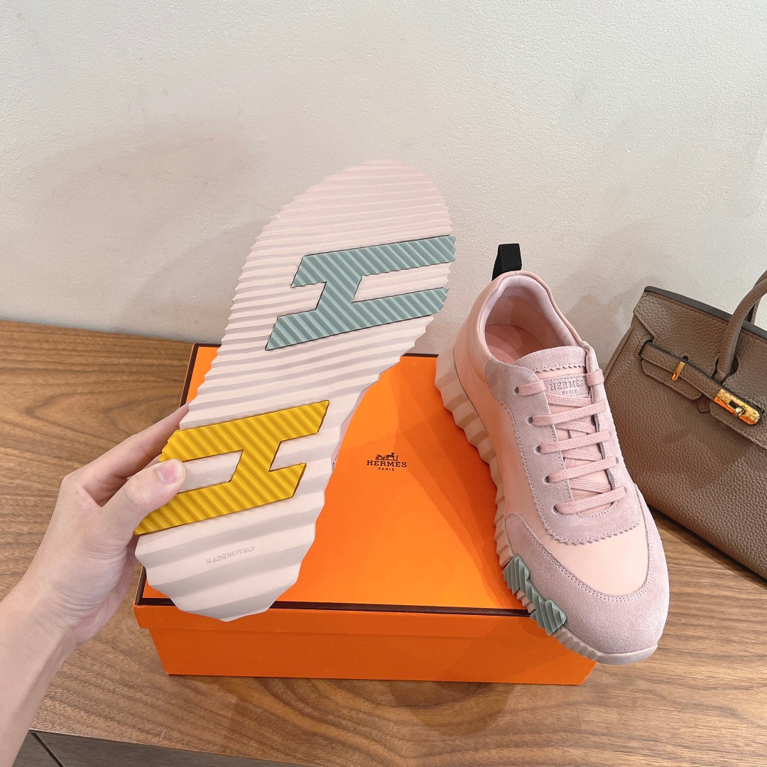 Hermes pink sneakers with outsole view, striped tread and green-yellow accents