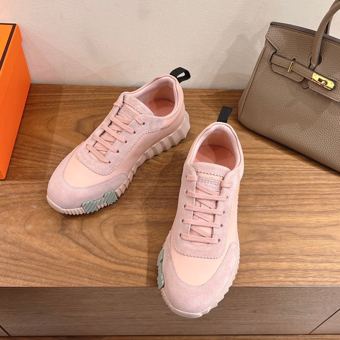 Hermes pink sneakers, side view, lace-up design with light sole and tread
