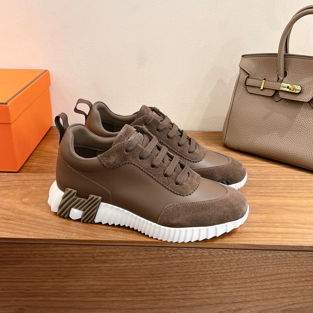 Hermes unisex sneakers with taupe suede panels, lace-up design, and white sole tread