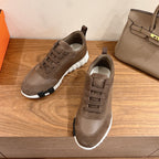 Hermes unisex lace-up sneakers with taupe suede uppers and cushioned white sole