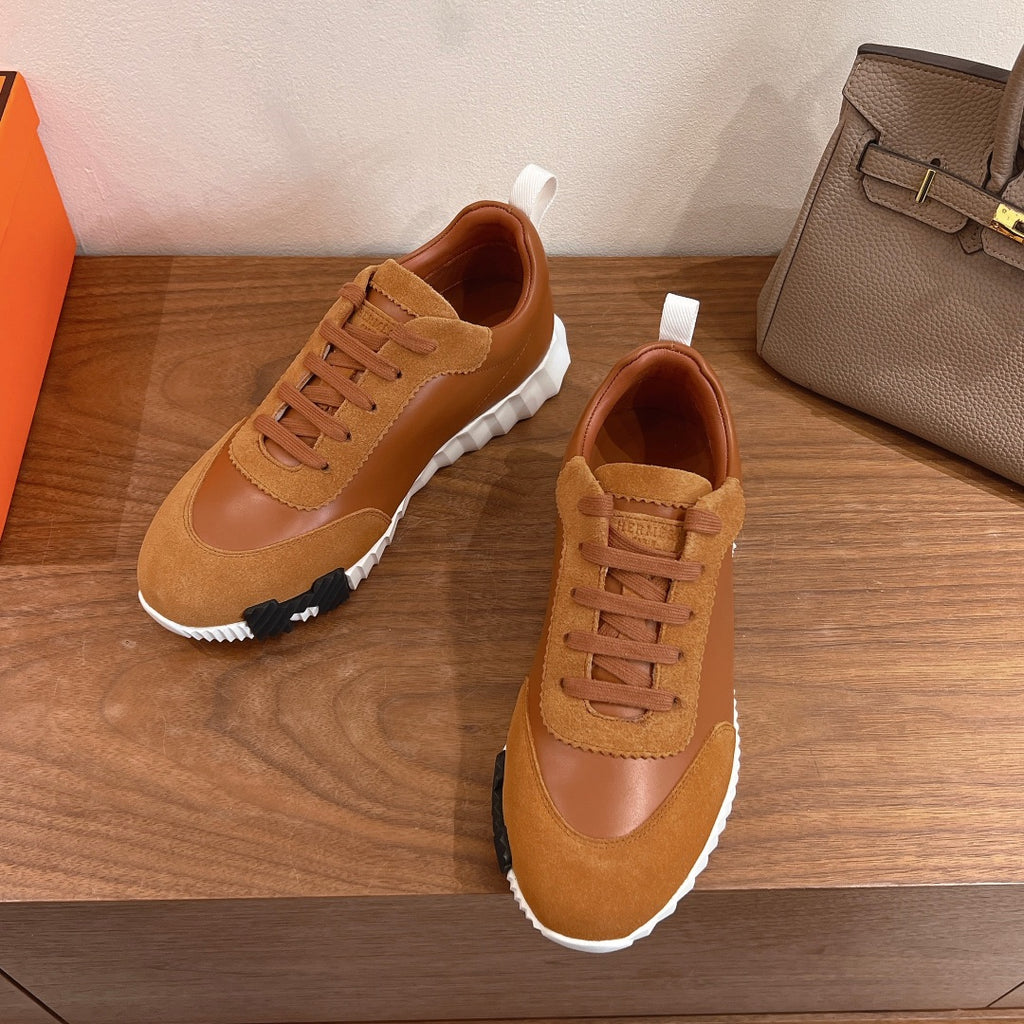 Tan lace-up sneakers with suede quarter panel and white rubber sole