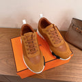 Tan lace-up sneakers with stitched toe cap, white sole and visible laces