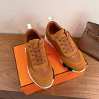 Tan lace-up sneakers with stitched toe cap, white sole and visible laces