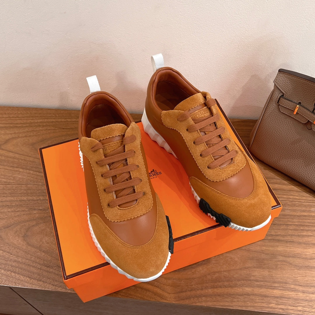 Tan lace-up sneakers with stitched toe cap, white sole and visible laces