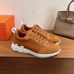 Tan low-top sneakers with lace-up front and thick white tread sole