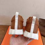 Tan sneakers rear view with white pull tabs and thick white sole