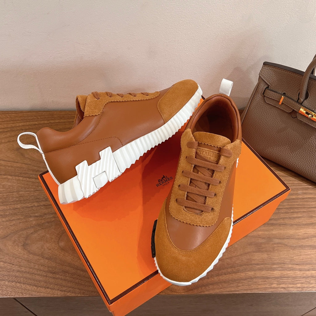Tan lace-up sneakers with suede overlays and white ridged sole