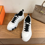 Unisex luxury sneakers, white with black lace-up trim and rugged rubber sole