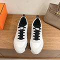 Unisex luxury sneakers, white leather with black laces and black heel accents
