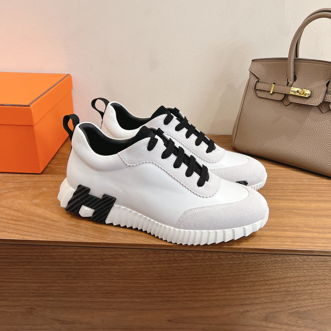 Unisex luxury sneakers, white with black laces and chunky sole detail