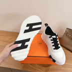 Unisex luxury sneakers, outsole view with bold black traction stripes