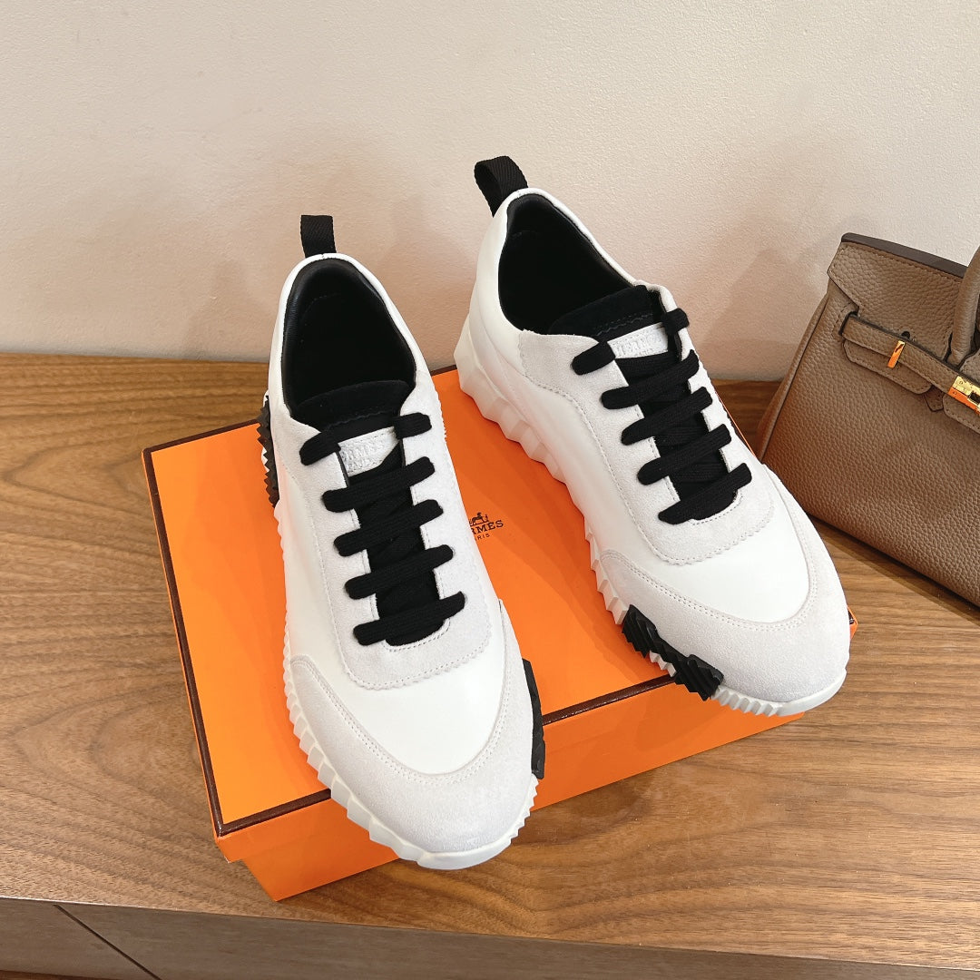Unisex luxury sneakers, white uppers with black lace-up panels and thick sole
