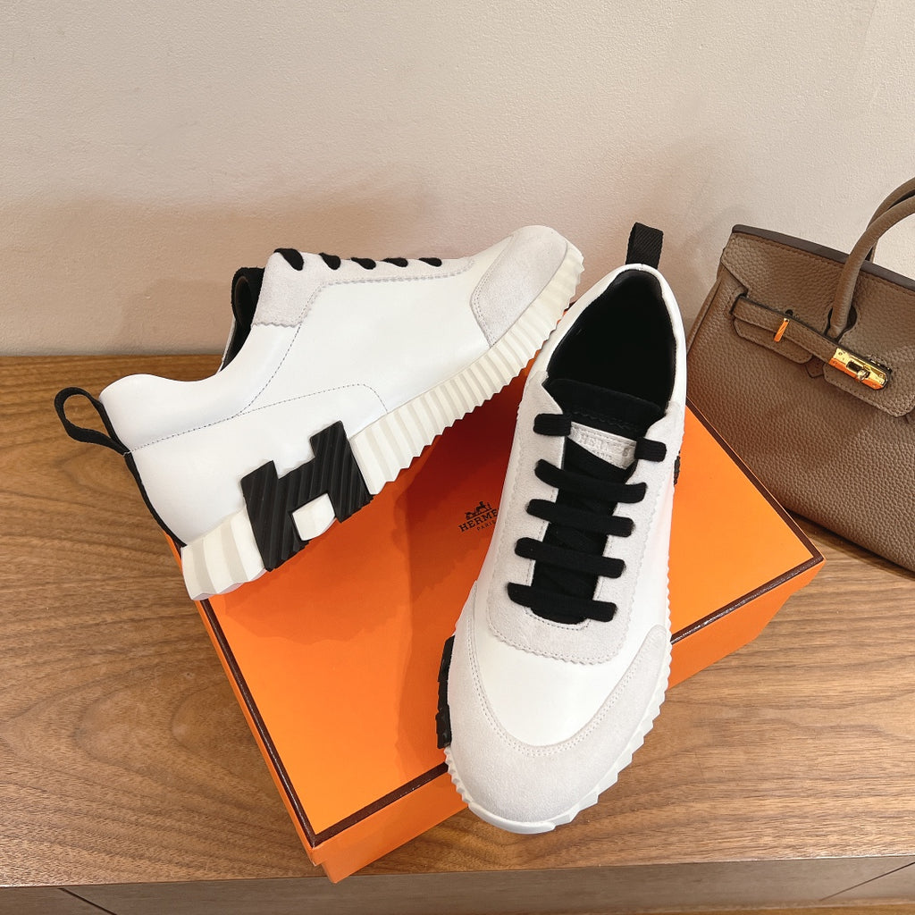 Unisex luxury sneakers, white leather with black laces and textured tread sole