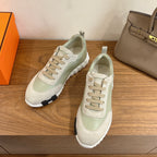 Unisex pale green and off-white low-top sneakers with lace-up closure and white outsole