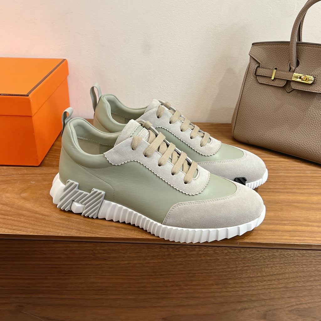 Chunky low-top sneakers in pale green and off-white with lace-up front and ridged sole