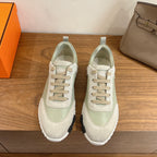Unisex sneakers in pale green and off-white with lace-up front and white rubber sole