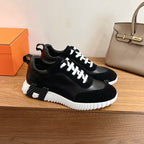 Black leather-look sneakers with white laces and thick white platform sole