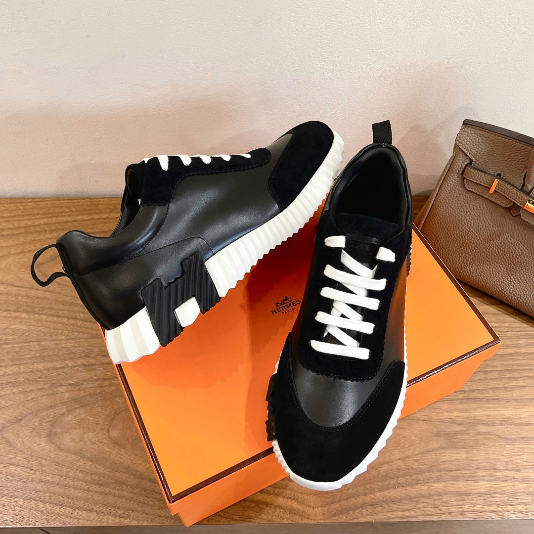 Black sneakers with white laces and white-and-black paneling detail