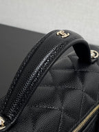 Chanel bag handle and quilted texture close-up with gold double C emblem