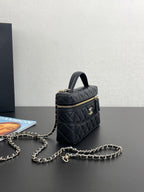 Chanel quilted top-handle bag with gold-tone hardware, chain strap, and front zipper