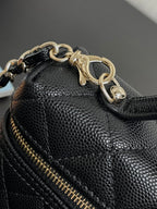 Chanel bag close-up of textured leather, gold chain, and gold-tone zipper pull