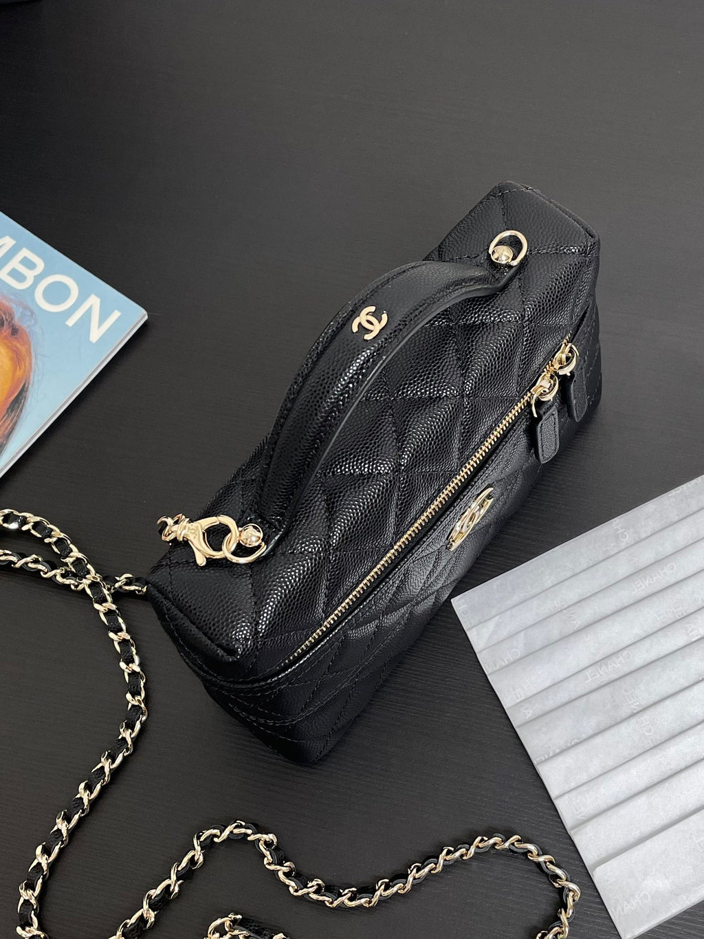 Chanel quilted crossbody bag with gold-tone hardware, front zipper, and chain strap