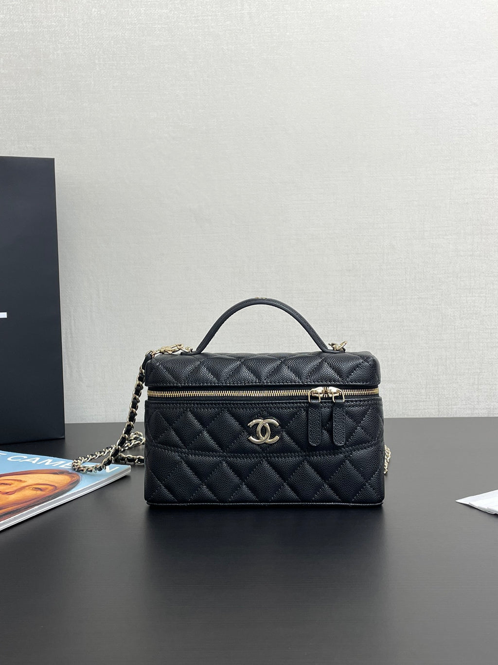 Chanel quilted top-handle bag in dark blue with gold-tone logo and zipper closure