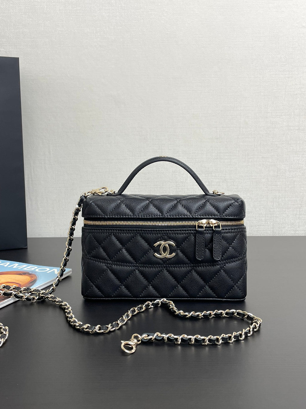 Chanel quilted shoulder bag with gold-tone logo, front zipper, and chain strap