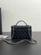Chanel quilted mini bag with top handle, gold-tone logo, and front zipper detail