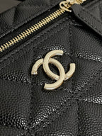 Chanel bag front close-up with gold-tone double C logo and textured quilted leather