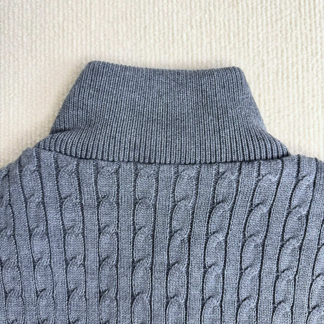 Ribbed knit collar and cable-knit sleeve section on a light blue puffer jacket