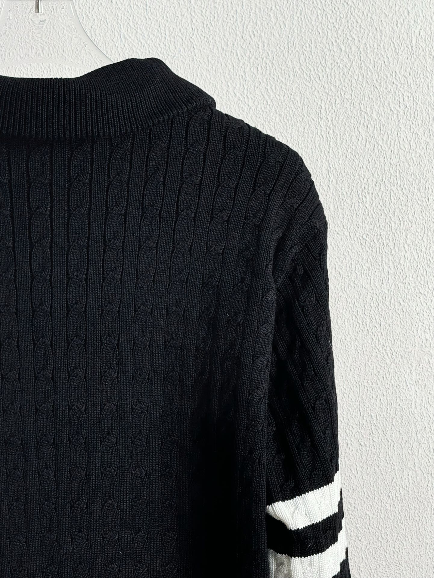 Dark navy ribbed knit back panel with white stripe detail on a quilted jacket