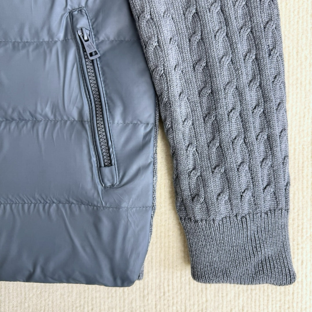 Long puffer jacket front with centered zipper and ribbed knit sleeve panel