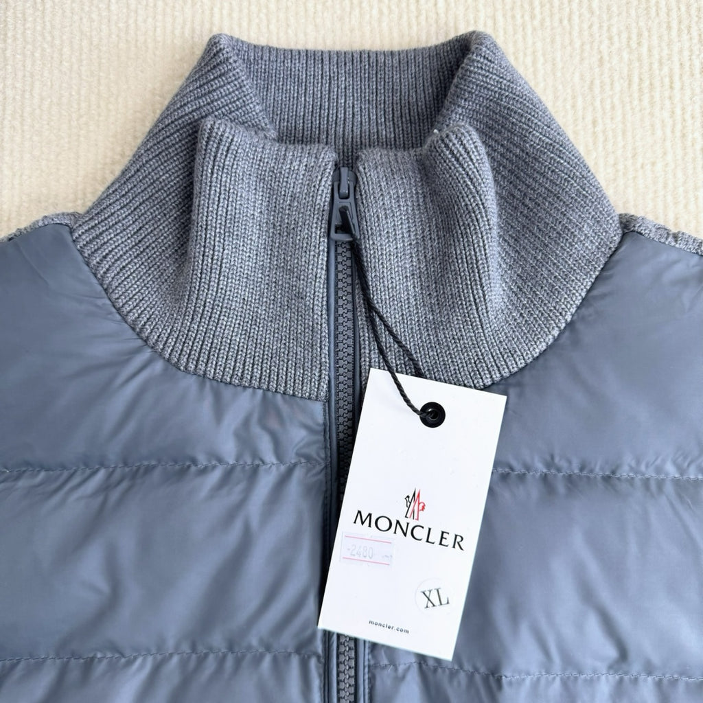 Long puffer jacket with knit collar, front zipper, and attached brand tag