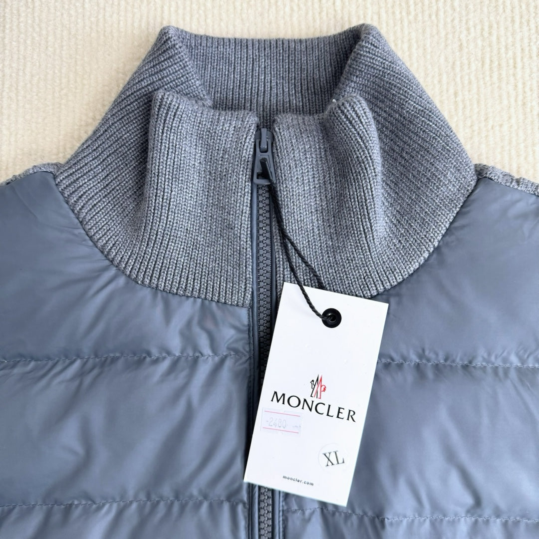 Long puffer jacket with knit collar, front zipper, and attached brand tag