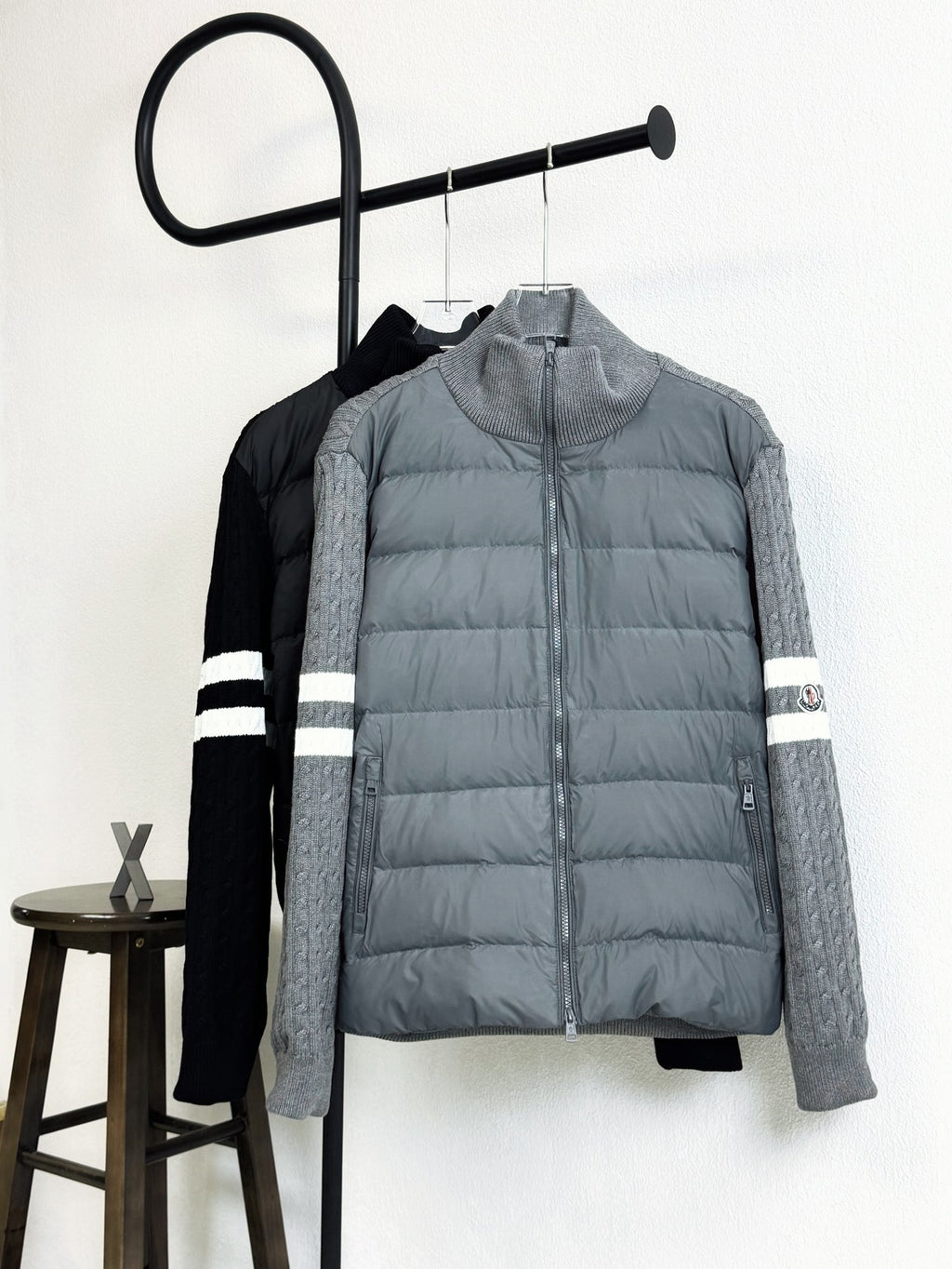 Light gray quilted puffer jacket with zip front and striped sleeve cuffs
