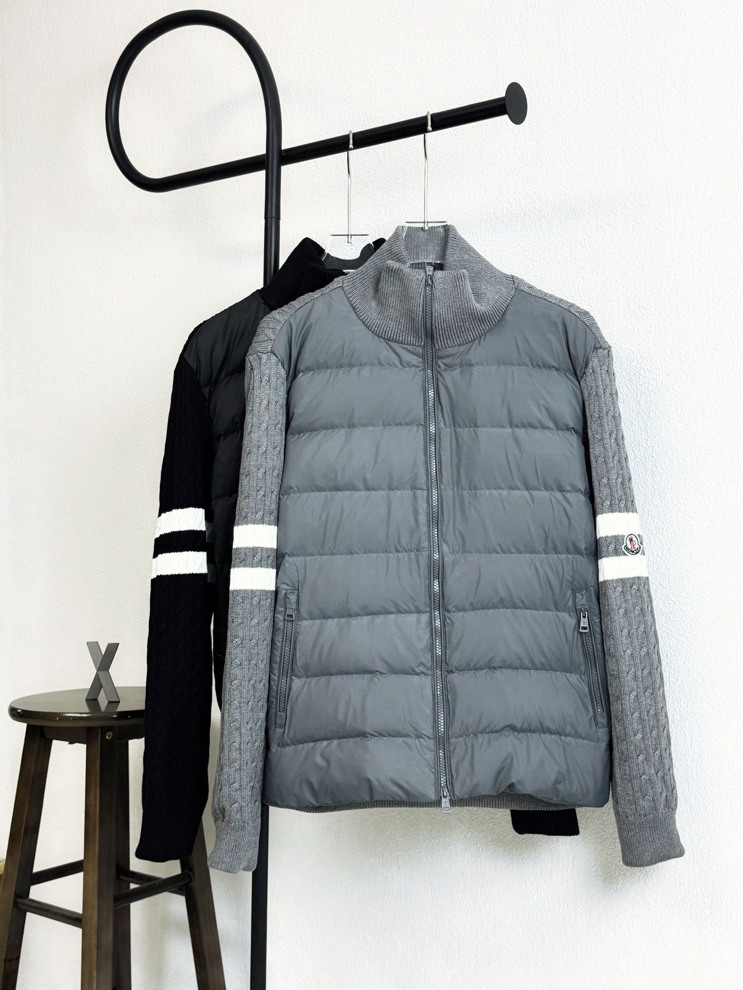 Light gray quilted puffer jacket with zip front and striped sleeve cuffs