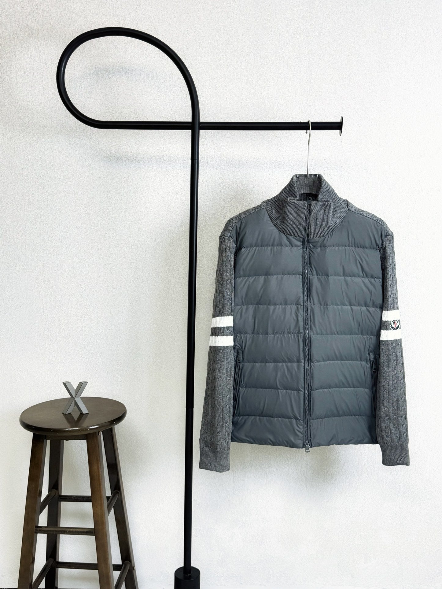 Gray quilted puffer jacket with zip front and white striped sleeve cuffs