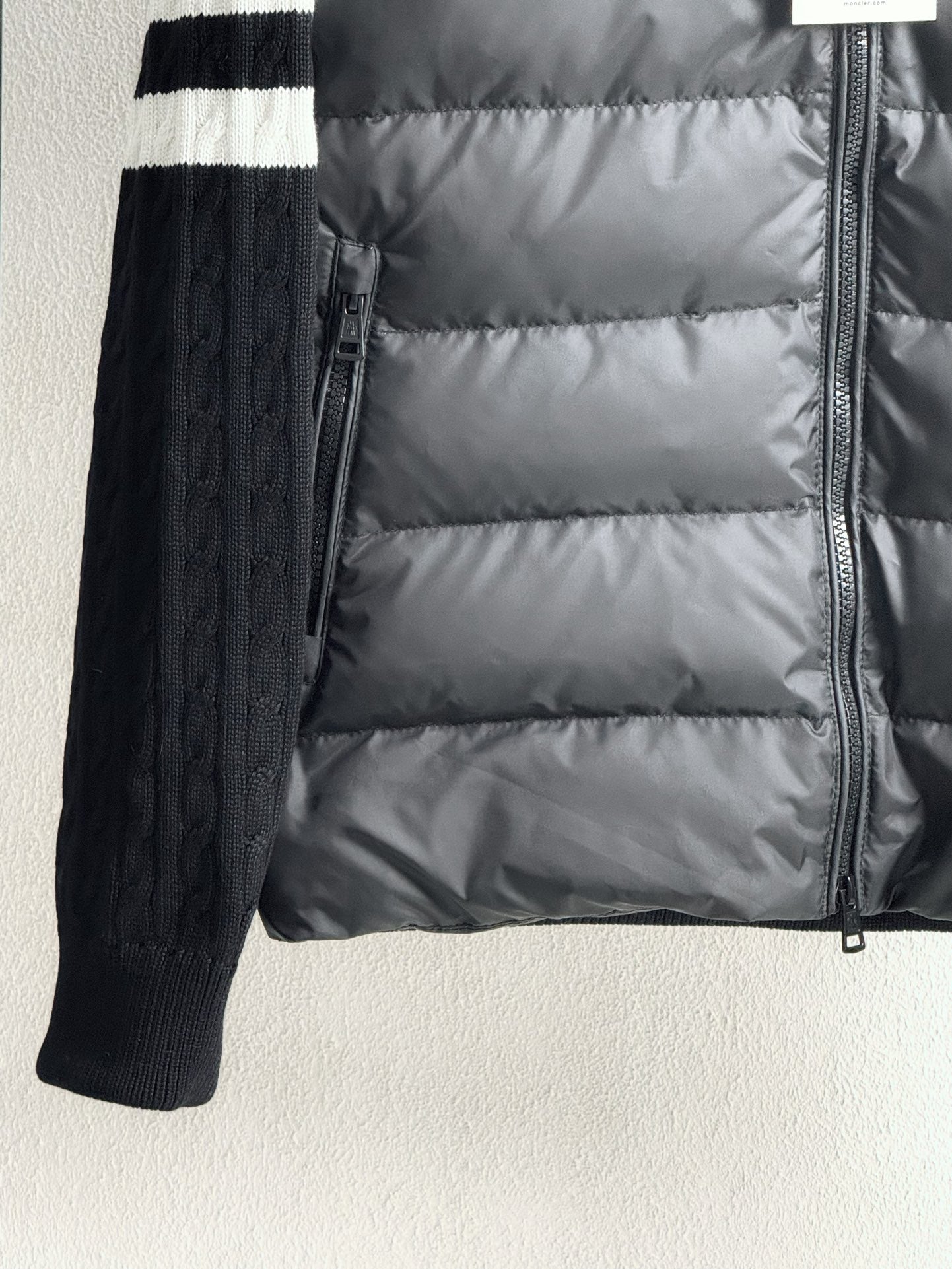 Long puffer jacket with front zipper and ribbed knit sleeves, striped cuffs