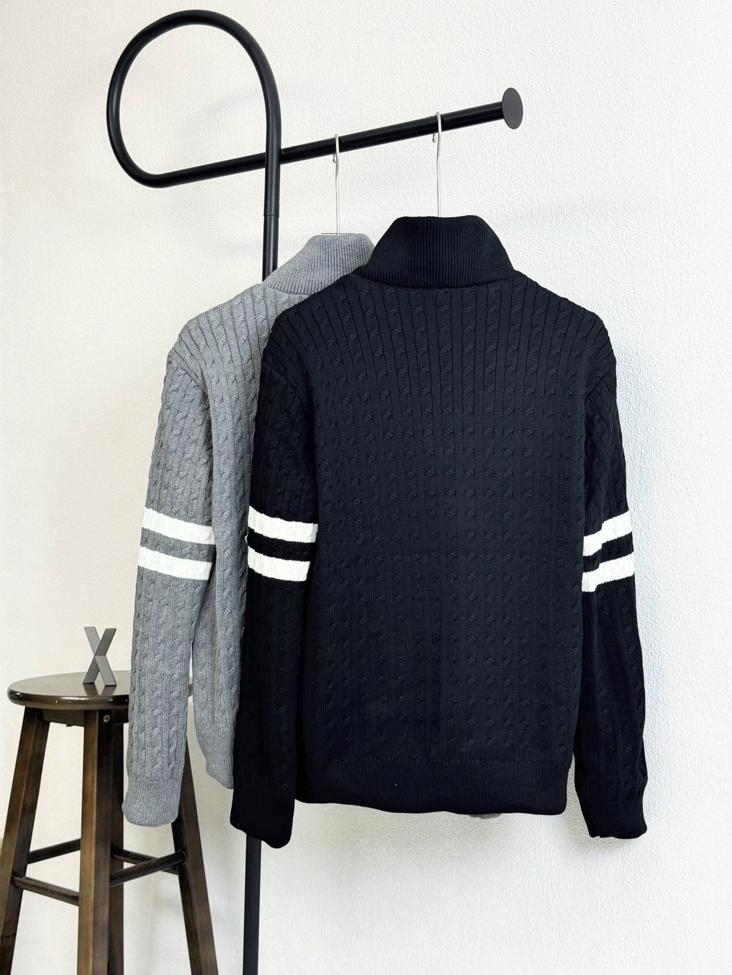 Dark navy quilted puffer jacket with high knit collar and striped sleeve bands