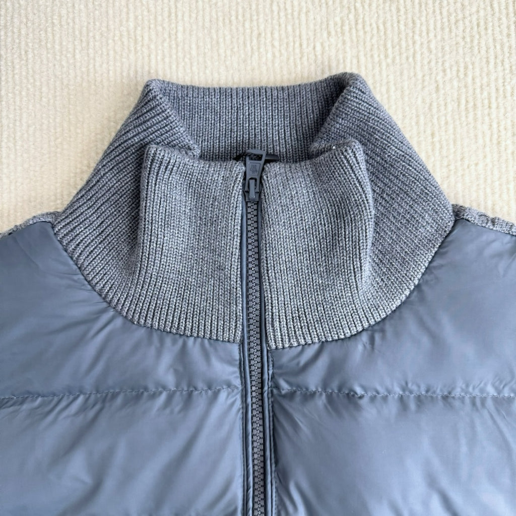 Long puffer jacket with stand collar and front zipper under knit ribbed trim