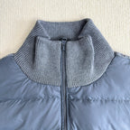 Long puffer jacket with stand collar and front zipper under knit ribbed trim